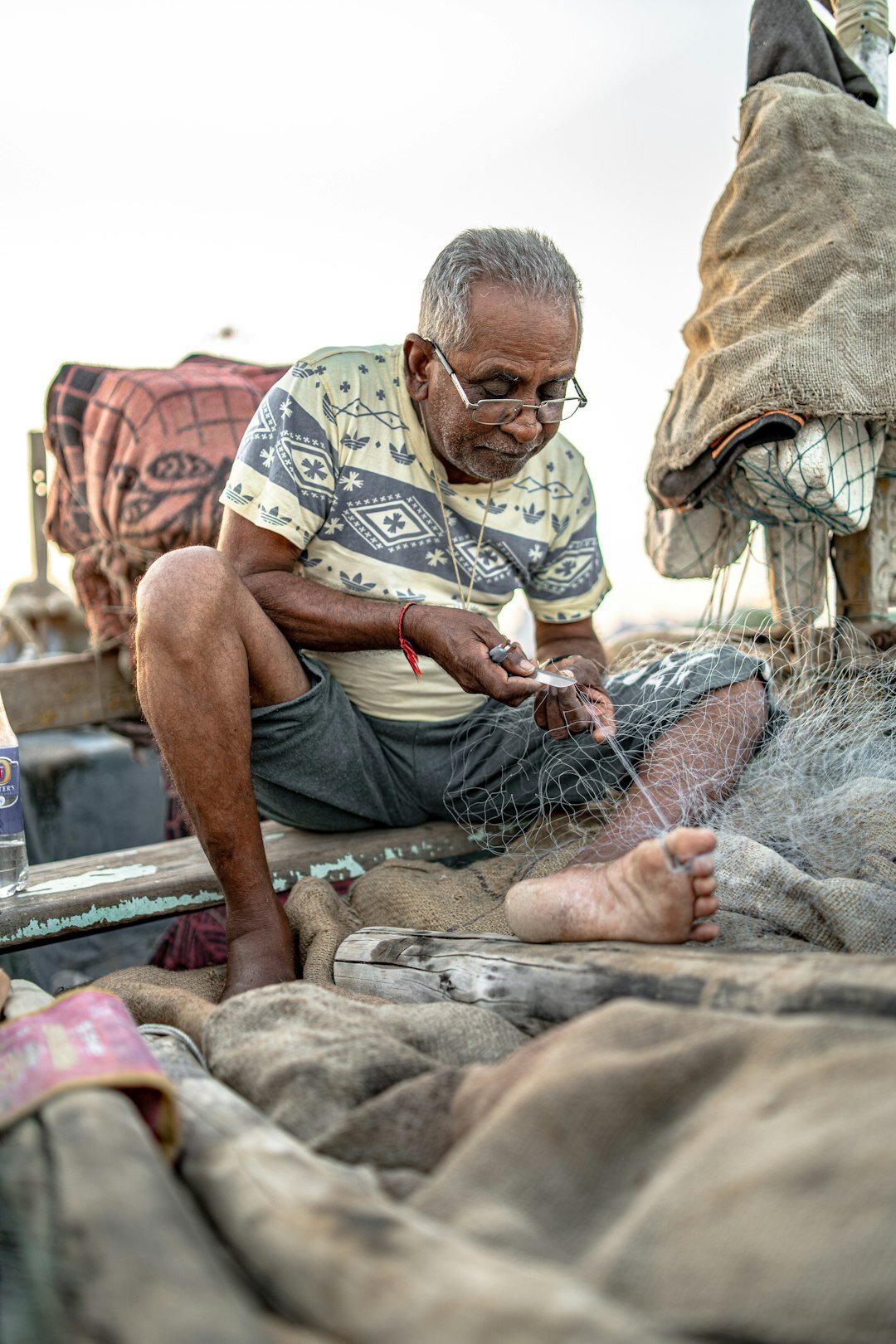 Danish fisherman mending nets on a boat